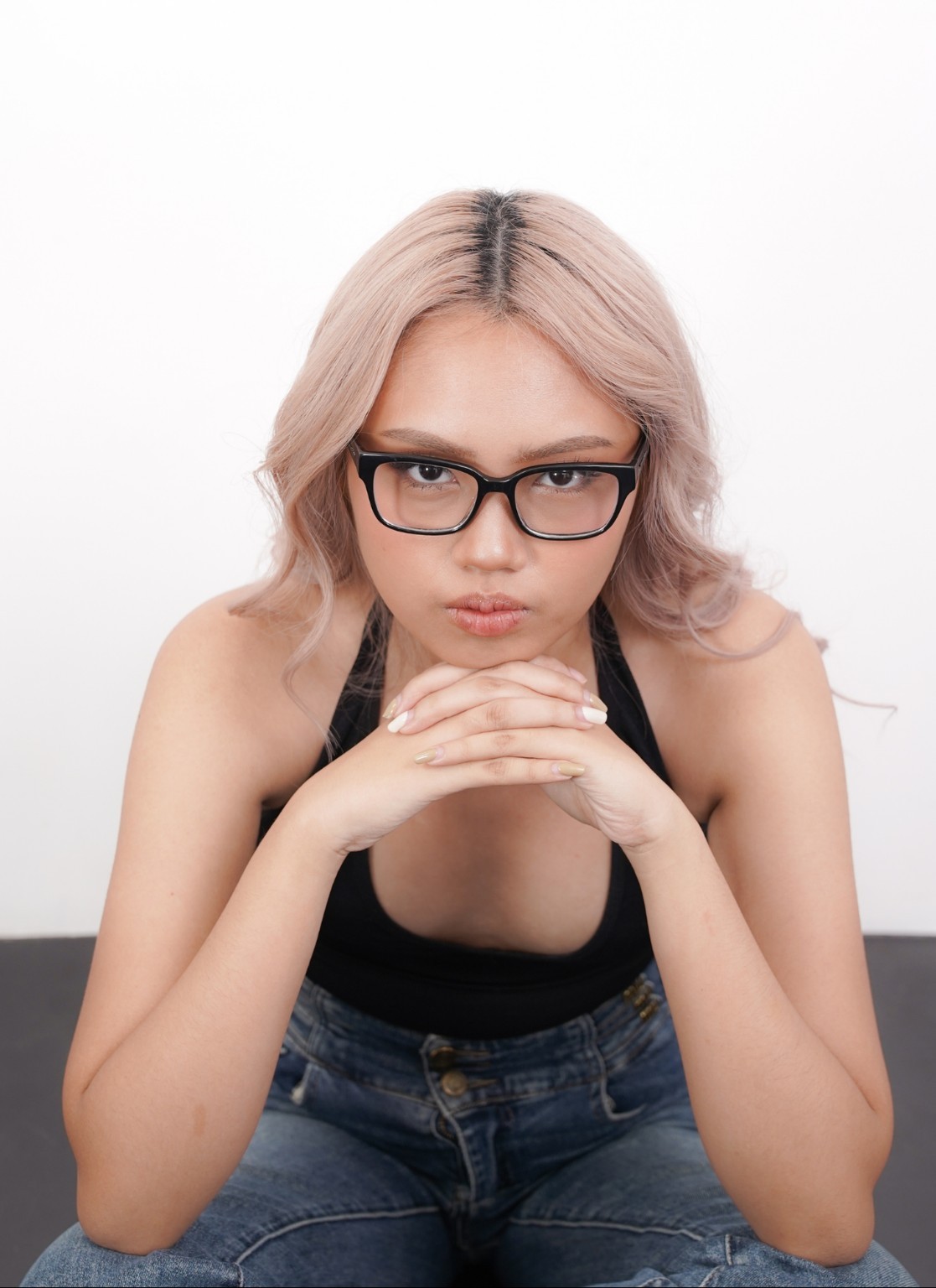 Close studio portrait of Althea Louise wearing glasses